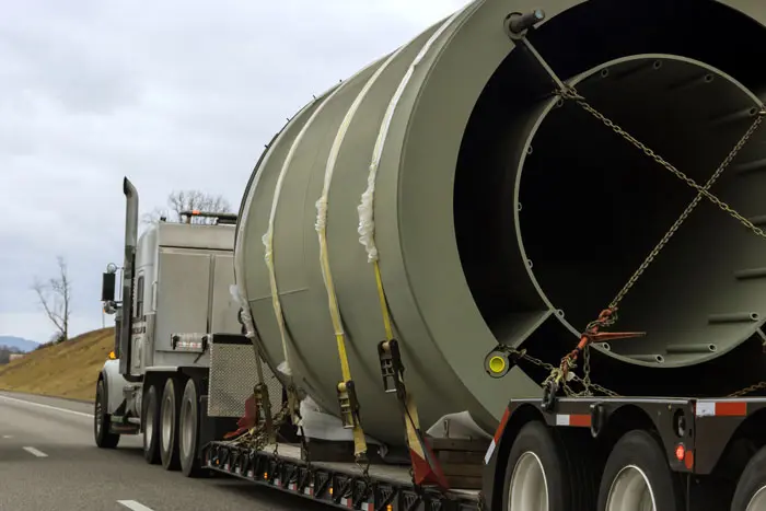 a semi truck with a special wide load cargo on the road