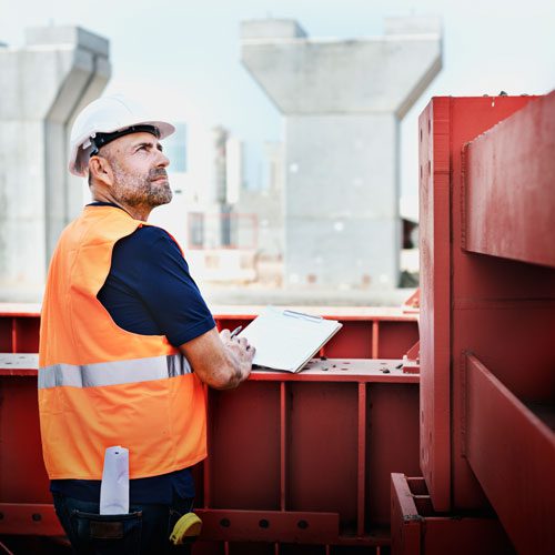 a shipping yard employee standing with a clipboard